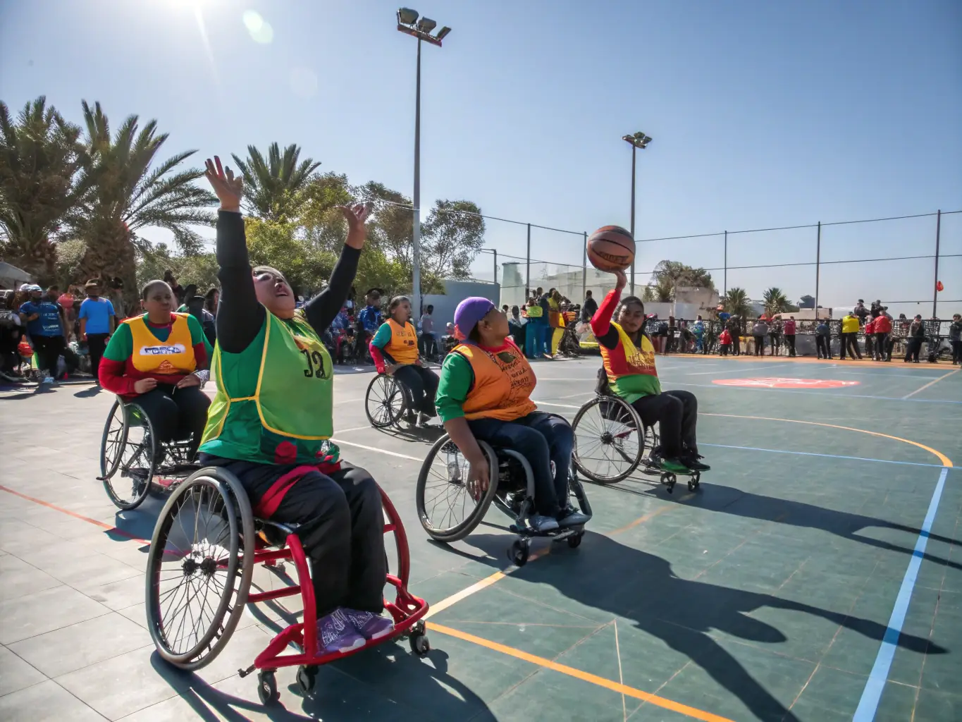 A dynamic image of adults with autism participating in a team-based outdoor game, such as adapted volleyball or soccer. The focus is on teamwork, communication, and the joy of playing together.